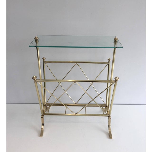 This beautiful and elegant neoclassical-style magazine rack is made of brass with a glass top. It is a French work by the...