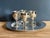 Set of four small stemmed cordial goblets in silverplate, with a plain round silverplate tray. Marked to the underside of...