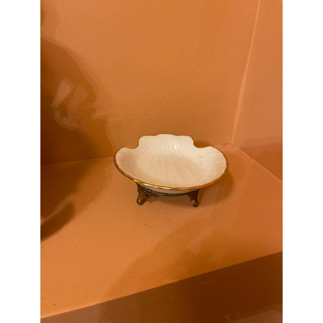 Gilt Rim White Porcelain dish in the form of a shell mounted on a three legged Louis XV rococo footed base. Perfect on a...