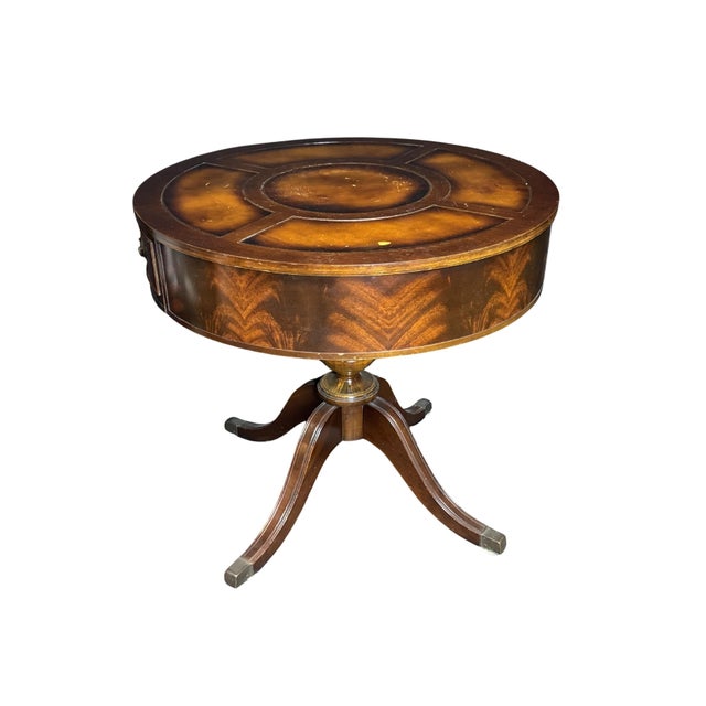 An elegant antique Duncan Phyfe style drum table crafted in rich mahogany and topped with inset leather beautifully...