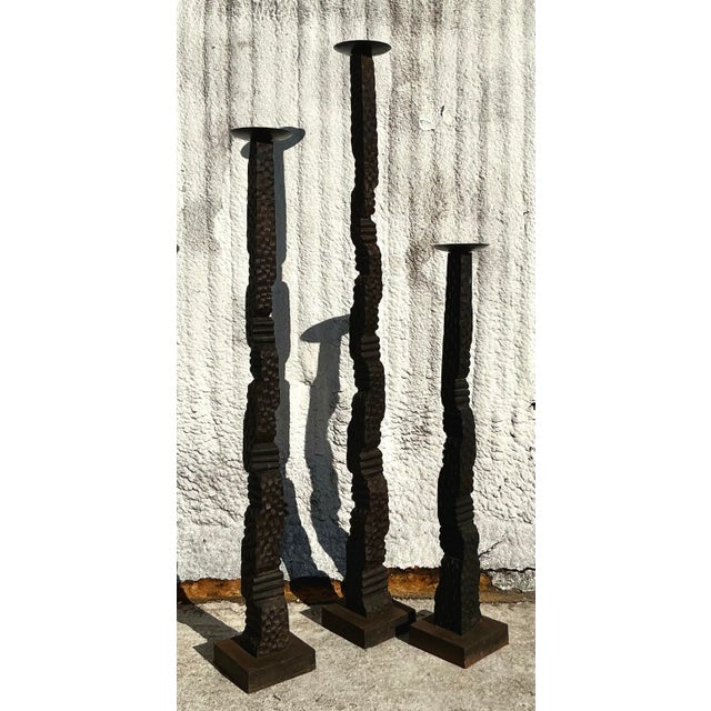 Elevate your interior with this stunning trio of vintage floor candle stands. Featuring an organic, textured design and a...