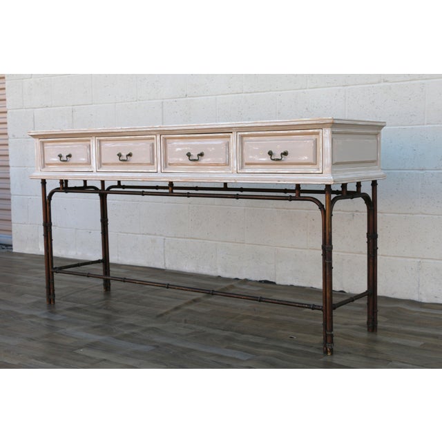 Wonderful vintage Hollywood Regency console table, circa 1970s, featuring a beautifully distressed painted wood case...