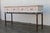 Wonderful vintage Hollywood Regency console table, circa 1970s, featuring a beautifully distressed painted wood case...
