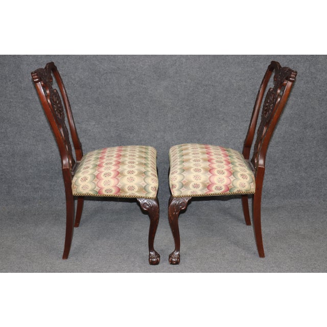 Refine your interior with this exceptional pair of 1890s Georgian-style carved walnut side chairs, masterfully crafted to...