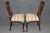 Refine your interior with this exceptional pair of 1890s Georgian-style carved walnut side chairs, masterfully crafted to...