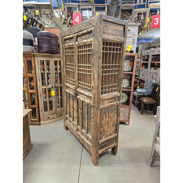 Bring a touch of soulful, rustic character to your space with this stunning Chinese armoire. Defined by its striking...