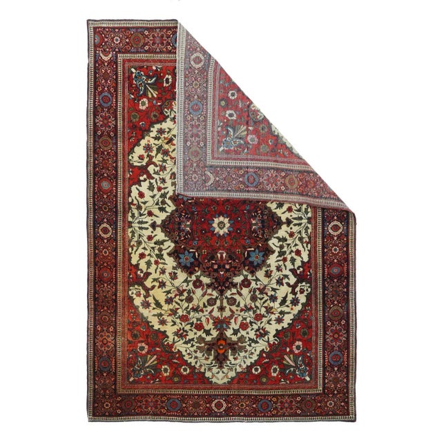 Antique Farahan Sarouk Rug 4'3'' x 6'4''. On an ecru field scattered with flowers and a structural vinery, is set a large...
