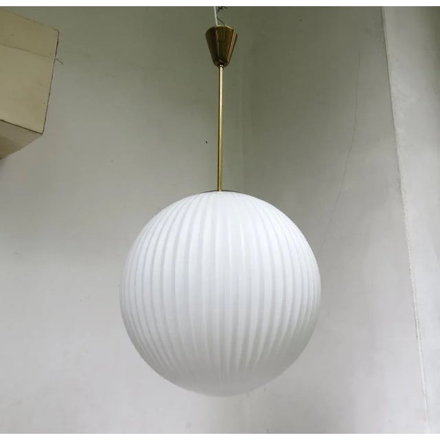 A large, extremely rare ceiling lamp "Pleated" from the 50s. The lamp shade is flashed glass white in pleated look. The...