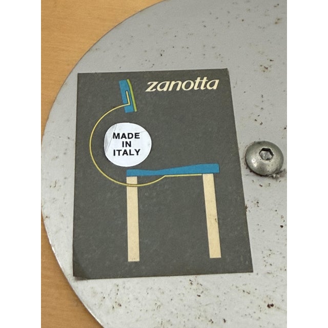"Potto" magazine rack by Andrea Branzi for Zanotta, 1993. It features a chromed steel frame, wicker basket, and glass top....