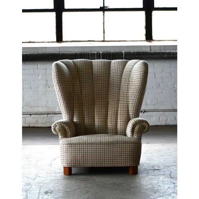 Super charming and very unusual highback lounge chair from around 1950. Very unusual proportions with quite a low seat and...