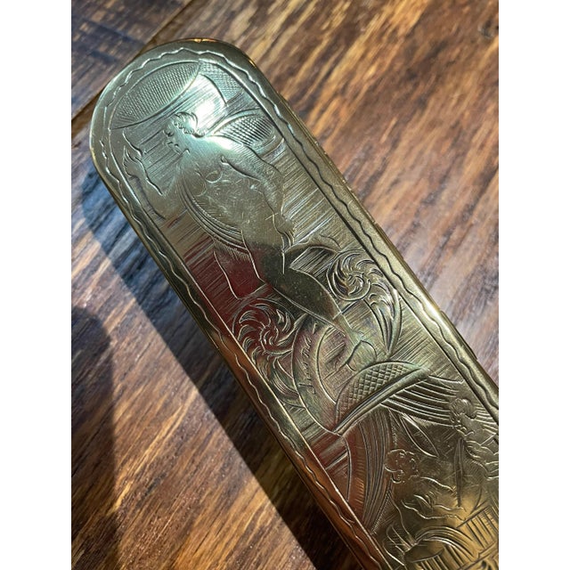 The style of this Dutch brass tobacco box was popular in the mid 1700s. The engraving is beautiful and the scandalous...
