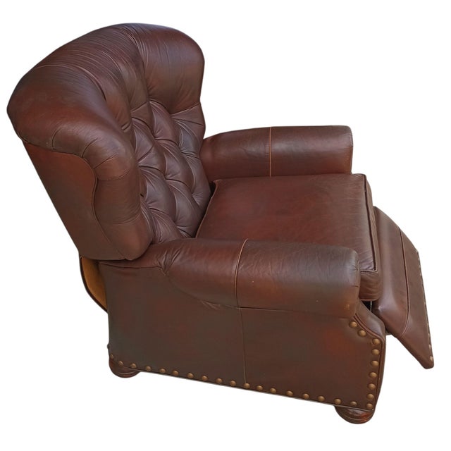 Vintage Ethan Allen Cromwell Tufted Genuine Leather Recliner. It features a classic, cocooning Chesterfield-style design,...
