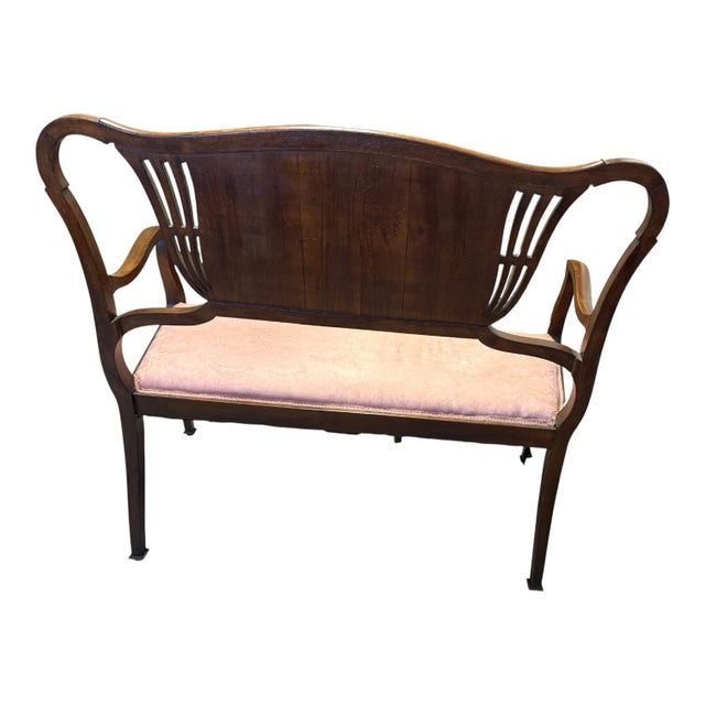 An elegant early 20th-century Federal/Neoclassical Revival two-seat settee distinguished by its graceful silhouette and...