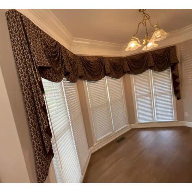 This custom-made swag valance is expertly tailored for a bay window, offering a refined and elegant finishing touch to any...