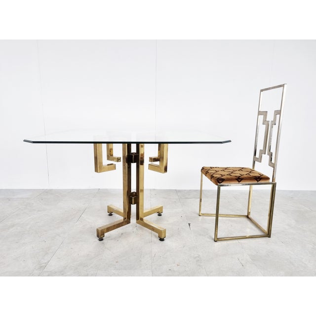 Striking geometrical brass dining table witha clear beveled glass top. Glass can be changed uppon request. 1970s - Belgium...