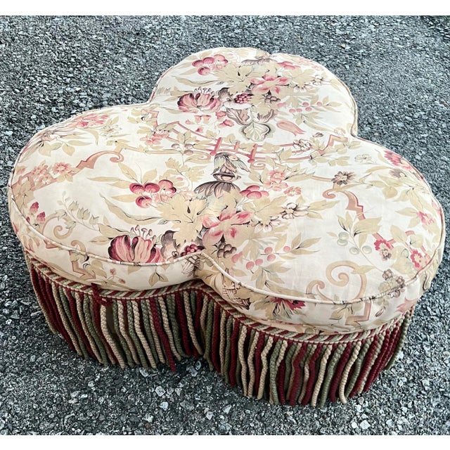 George Smith Clover Pouf Ottoman in Gollut fabric. Down filled seat and fringe with rolling casters.