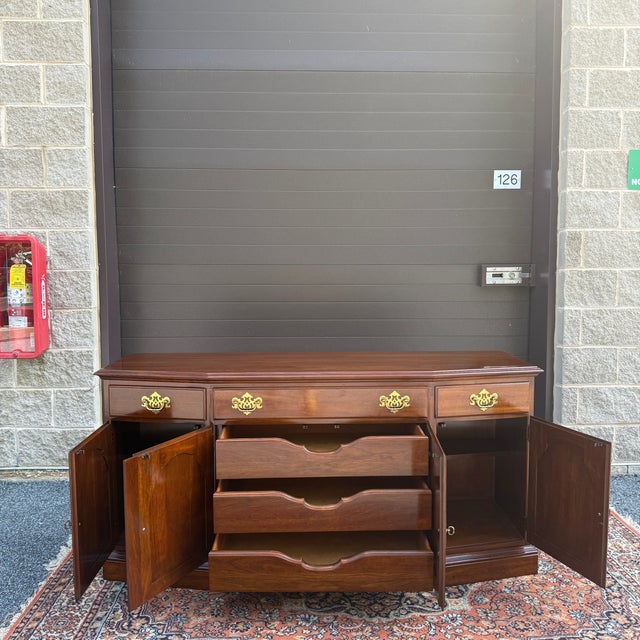 A late 20th century Knob Creek Traditional Georgian solid cherry buffet or sideboard having a row of three dovetailed...