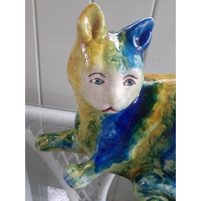 A wonderfully expressive Italian majolica cat sculpture dating to the mid-20th century, hand painted in saturated tones of...