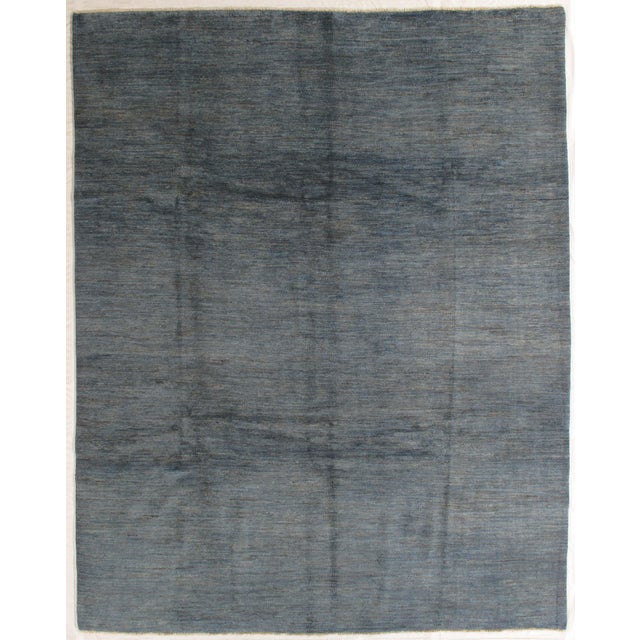 Vintage hand-knotted Pakistani Gabbeh rug featuring a minimalist field with subtle tonal variation and soft abrash. Gabbeh...