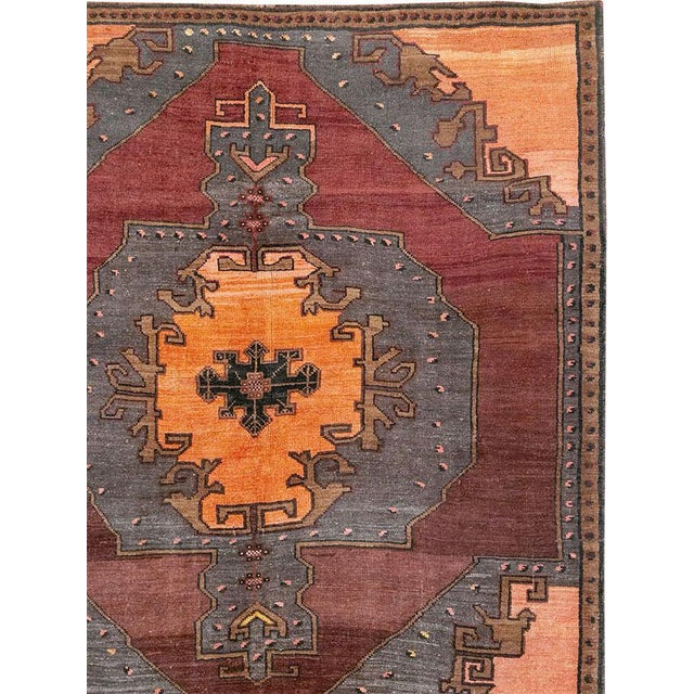 This Mid-20th century Turkish Anatolian square large room-size carpet presents a bold, compartmentalized composition in...