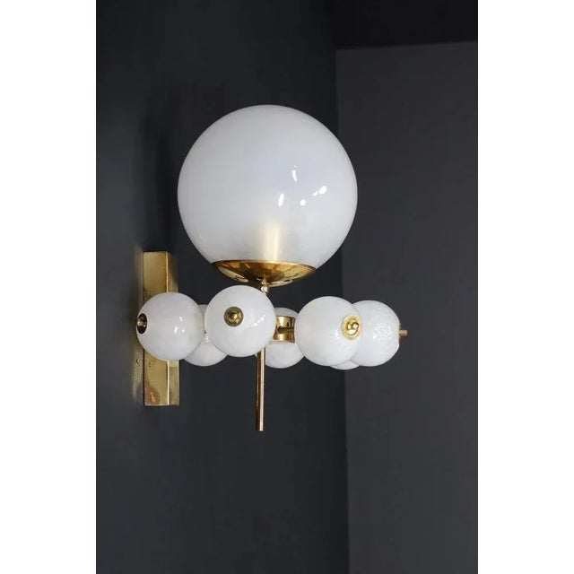 This stunning mid-century wall light features a brass fixture designed and produced by the renowned preciosa factory in...