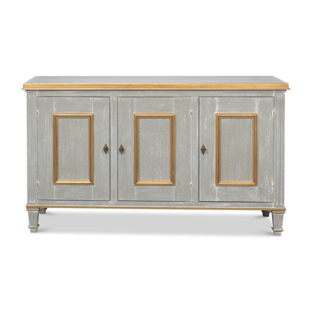 Gilt traces the panel moldings on a gray case, continuing along the top edge, base rail, and tapered feet. The grey is...