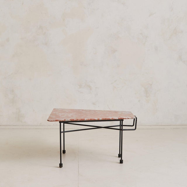 A pair of 1950s Italian coffee tables attributed to Augusto Bozzi. Their asymmetrical surfaces are hand-cut with softly...