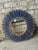 Vintage salvage wall mirror. This round wall mirror features a rusty metal boarder followed by a layer of blue fringe,...