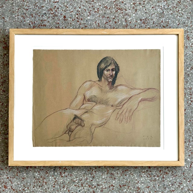 This life drawing portrays a reclining male nude, rendered with confident contour and restrained use of color. Subtle red...