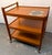 Elegant Danish mid-century modern bar cart by Brdr. Furbo, crafted in richly grained teak and distinguished by a striking...