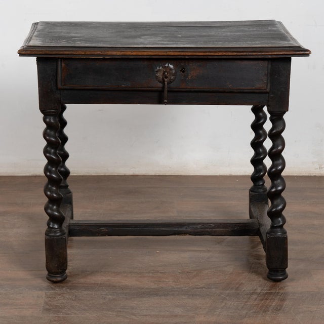 19th century Danish oak side table with a single drawer. Constructed of oak, the table features barley twist legs joined...