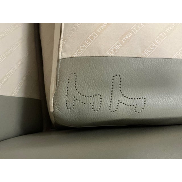 Low profile post-modern aesthetic with tailored tight back framing. Finished in soft sage gray pebble grain leather. Very...