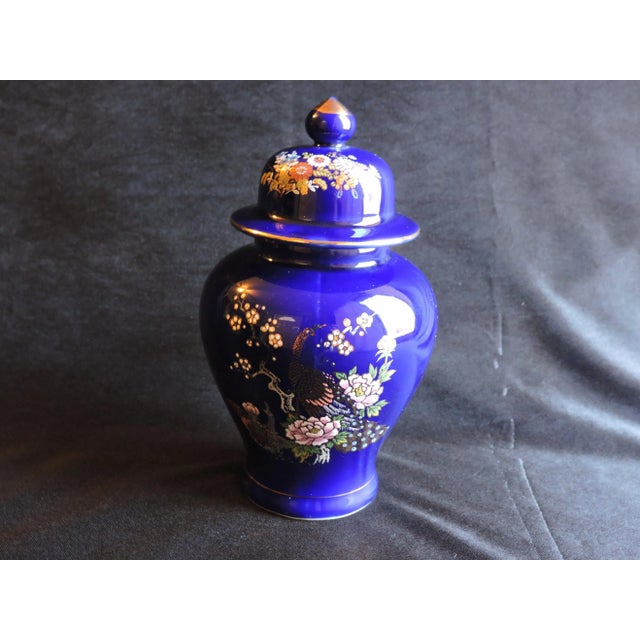 This hand painted cobalt blue ginger jar was made by the Kutani Ware Co. and it was hand painted in Japan around the...
