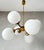This vintage Sputnik lamp is a beautiful addition to any interior. with its elegant six white glass globes and brass...