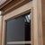 A 20th-century oak display bookcase. The upper section opens with three glass doors revealing adjustable shelves. The base...