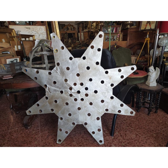 Luminous star with eight tips, wood covered in silver sheet. Italy 1940 to use as a Lunce point or to hang as an object of...