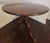 1770s English Georgian tilt top round walnut pedestal table with brass release. Hand turned pedestal on three cabriole...