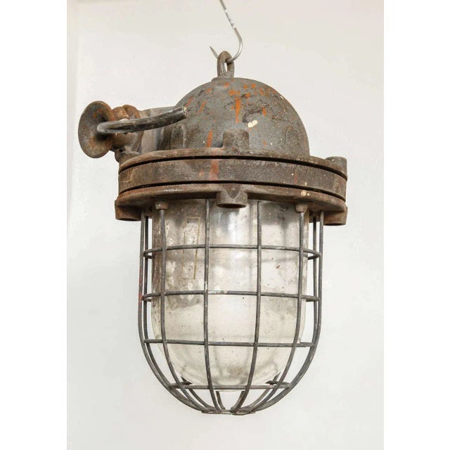 Industrial factory lamp shade and cast iron insert clear glass. Two pieces available. The lamps are in original vintage...