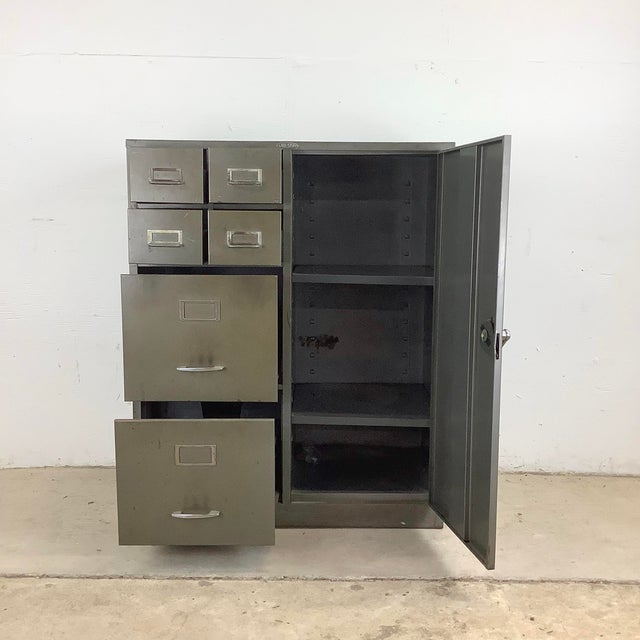 This vintage industrial steel cabinet with filing drawers embodies the rugged beauty and enduring functionality that...