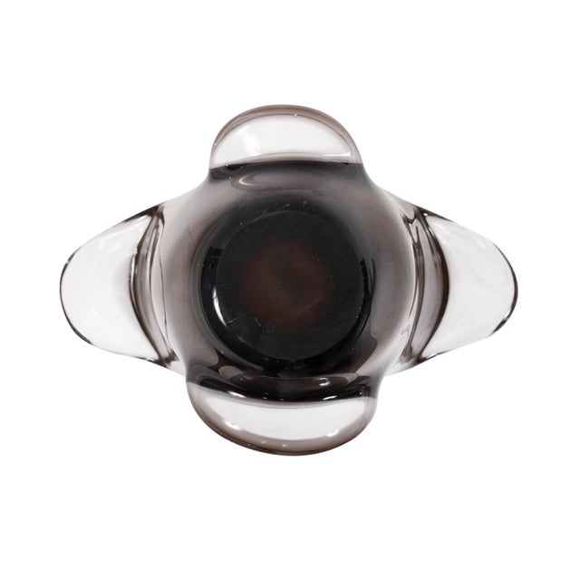 Featuring a sleek design and warm amber tones, this piece stands out with its fluid, sculpted shape, making it a...