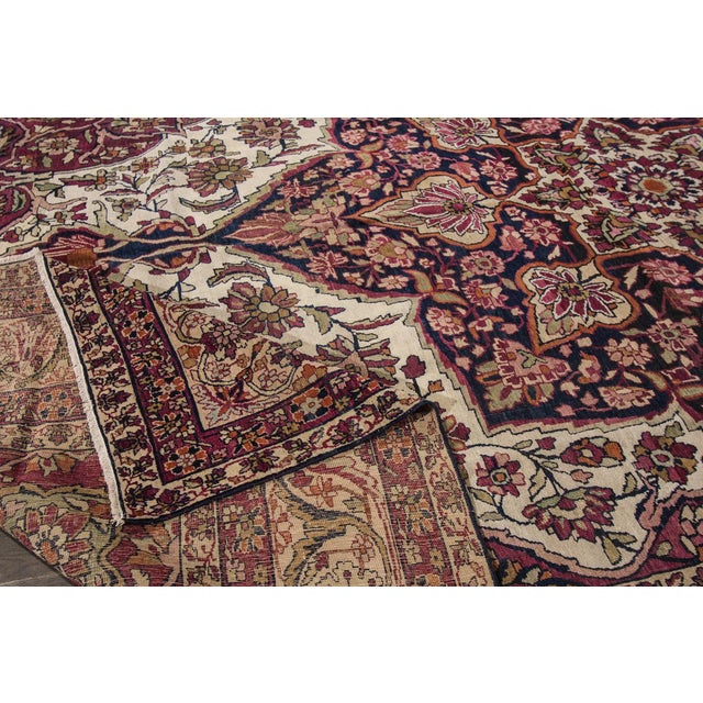 Beautiful hand-knotted wool, vintage Kerman rug. This rug has a ivory and rust field with an all over medallion floral...