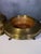 Antique copper and brass brazier divided into two parts, with a decorative top, mounted on three finely decorated legs. It...