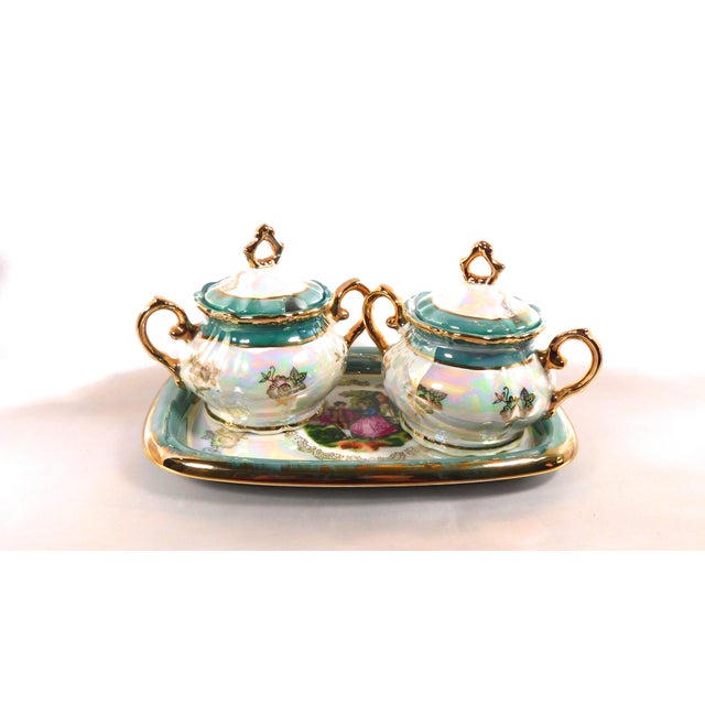 This ia a Royal Japan set of a serving tray and two covered sugar bowls ( or jelly jars and honey pots). The set is white...