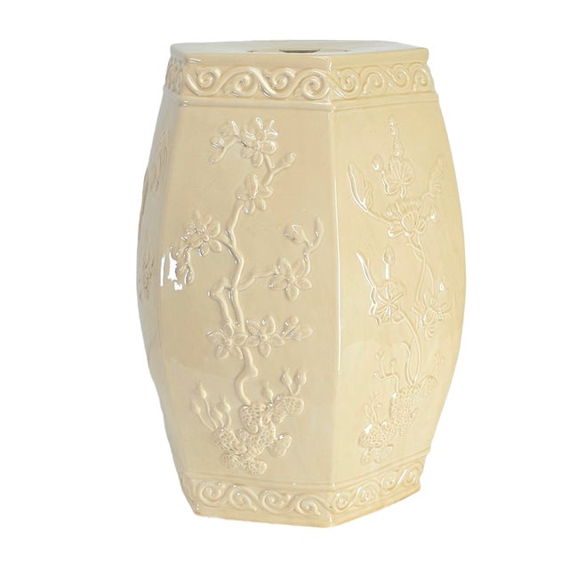Elegant Italian ceramic garden seat in hexagonal barrel form, finished in creamy blanc-de-chine glaze with raised floral...
