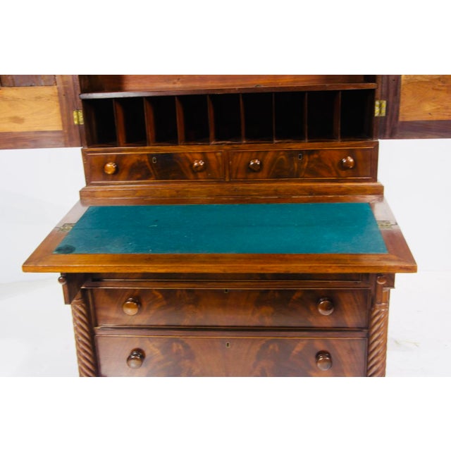 An exceptional and highly functional English Regency secretary chest of drawers, dating to circa 1815–1830, crafted in...