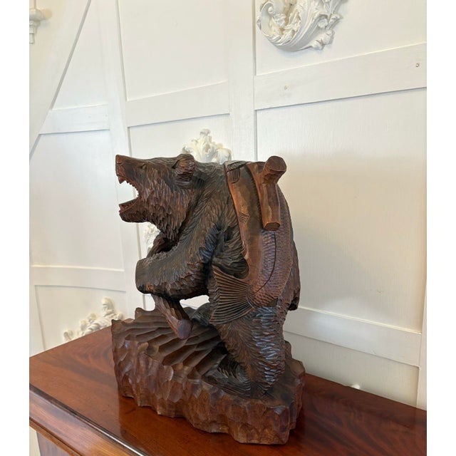 Large antique Edwardian quality carved linden wood Japanese bear carrying a fish having a large Japanese carved bear...