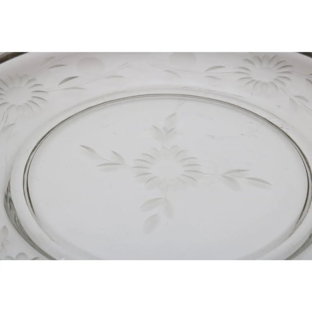 This stylish serving dish will make a definite hit at your next gathering with its sterling silver band and cut crystal...