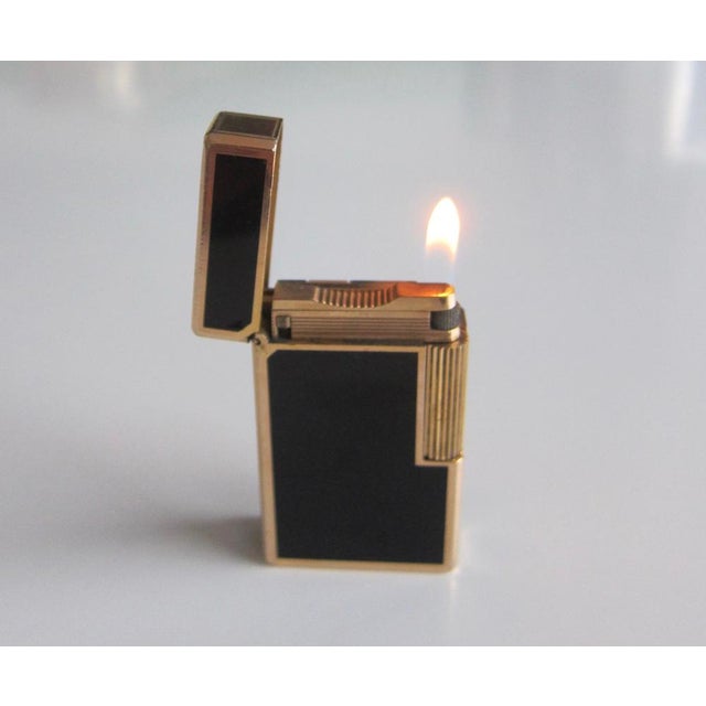 the rare hand-made black lacquer st dupont gold lighter has just returned from a complete overhaul at st dupont. it is in...