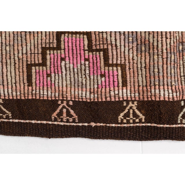 This is a vintage Turkish Oushak rug from the Mid 20th Century. The piece was hand-knotted.