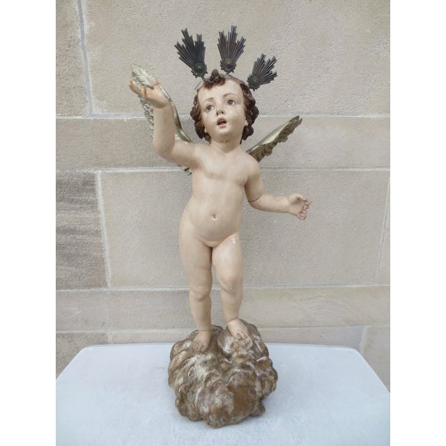 Beautifully carved wooden carved Putti with silver Heavenly Crown, Winged in silver leaf and polychromed over-all. The...